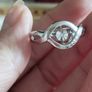 A 925 sterling silver ring with a floating diamond centerpiece. Image 7