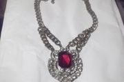 a lovely vintage  costome jewelley pendent with white stones and a large red stone