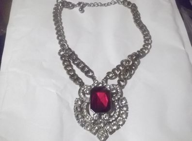 a lovely vintage  costome jewelley pendent with white stones and a large red stone