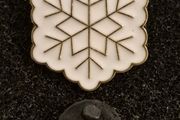 Snowflake,  pin back badge.