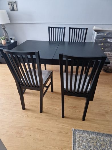 Black dining table with four chairs