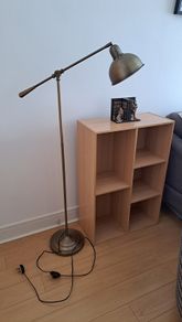 Vintage style floor lamp with chair and bookshelf