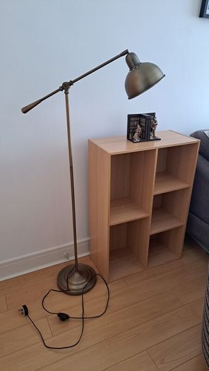 Vintage style floor lamp with chair and bookshelf