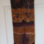Hand painted, 100% silk scarf featuring a hand-rolled hem and custom metallic gutta detailing. Image 3