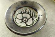 Vintage pottery pin dish featuring a Tudor Rose design. It is approximately 3 inches in diameter.