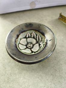 Vintage pottery pin dish featuring a Tudor Rose design. It is approximately 3 inches in diameter.