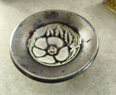 Vintage pottery pin dish featuring a Tudor Rose design. It is approximately 3 inches in diameter.