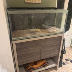 Large glass tank with matching storage cabinet stand