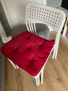 Four white plastic IKEA chairs