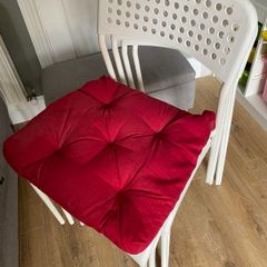 Four white plastic IKEA chairs