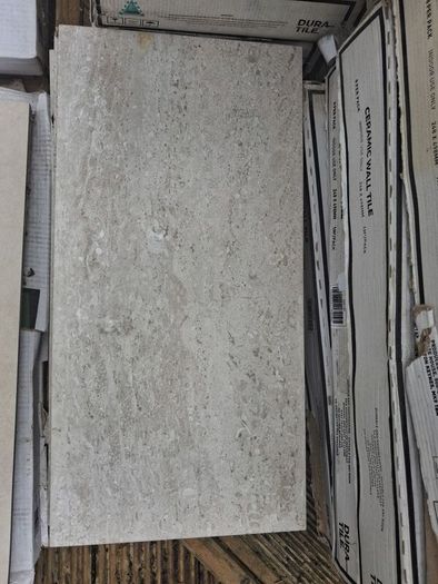 Enough for a small bathroom  wall and floor tiles. Cost 950 new  job cancelled will take 200
