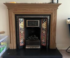 Wooden Fireplace with Tiled Cast Iron Surround