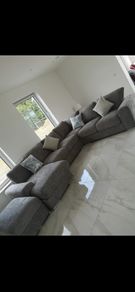 Large L shaped couch with foot stool