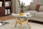 Round side table made of tempered glass with adjustable foot pads and steel frame