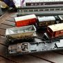Some random parts for hornby trains. Included is 2 British rail coaches in need of repair. A Harry Potter coach. Also various goods trucks Image 2