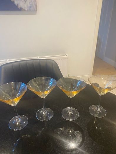 Set of four amber and plain glass martini or cocktail glasses