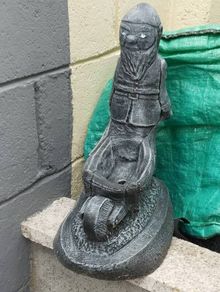 Man holding a wheelbarrow planter