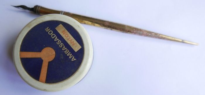 Vintage dip pen with collection of assorted nibs