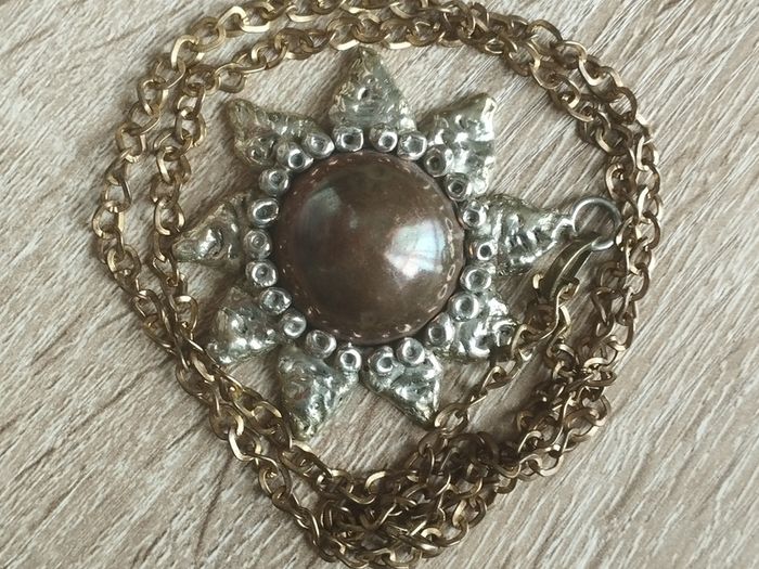 Vintage pendant on a long chain.