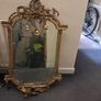 Two distinct antique giltwood mirrors with elaborate French-style ornamentation Image 4