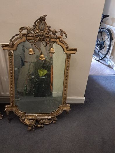 Two distinct antique giltwood mirrors with elaborate French-style ornamentation