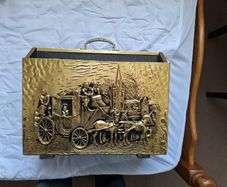 Vintage brass magazine rack with embossed stagecoach and horse scene