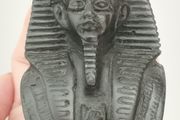 Vintage black statuette of an Egyptian pharaoh.