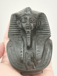Vintage black statuette of an Egyptian pharaoh.