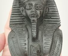 Vintage black statuette of an Egyptian pharaoh.