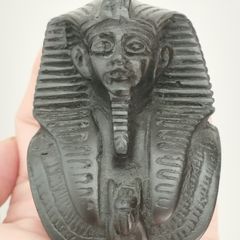 Vintage black statuette of an Egyptian pharaoh.