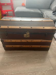 Old travellers chest , lined with super heroes and used as toy chest