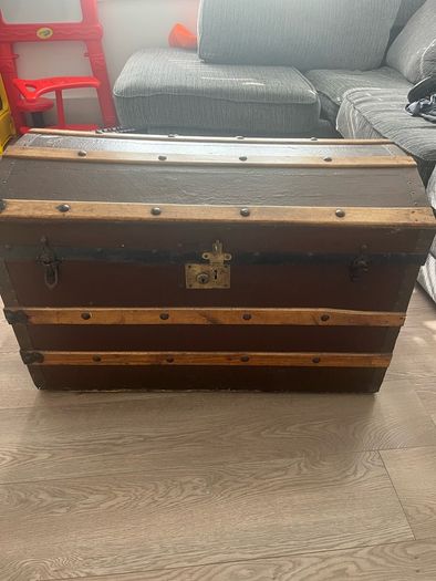 Old travellers chest , lined with super heroes and used as toy chest