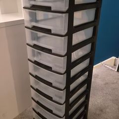 Tall plastic storage unit with drawers