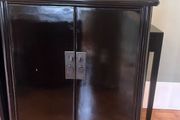 A pair of black laquered cabinets
