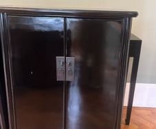 A pair of black laquered cabinets