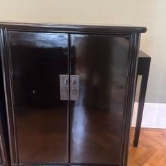 A pair of black laquered cabinets