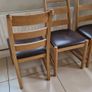 Marks & Spencer solid oak ladder-back dining chairs with 100% brown leather seat pads. Image 2