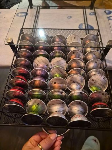 nespresso vertuo plus machine and coffee pods with holding tray