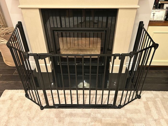 Black metal fire guard and safety gate