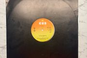 U2 - "Three" - 12" Vinyl  from 1979 - CBS 12-7951 - Second Release - Plain Black Sleeve, CBS Sunburst Labels