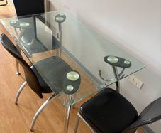 glass dining table with 3 leather chairs