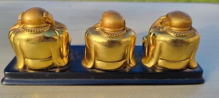 Three brass Buddha figurines