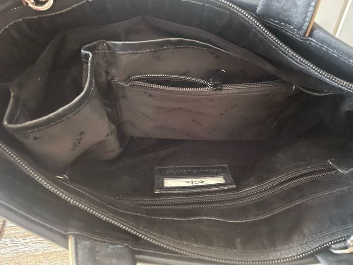 Tula black leather tote bag with a shoulder strap.