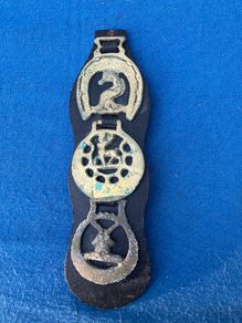 Vintage horse brasses on leather strap