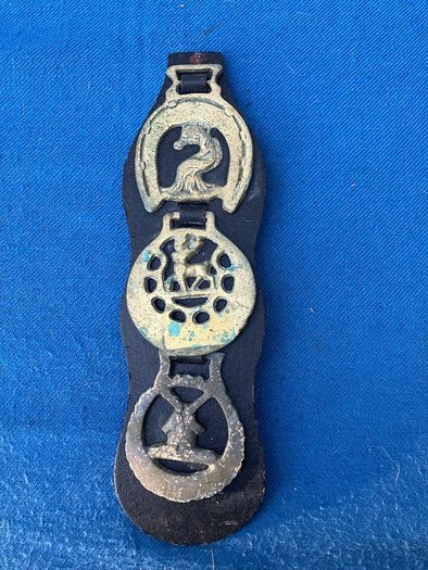 Vintage horse brasses on leather strap