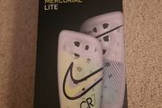 Nike, Mercurial Lite Size Medium shin guards with sleeve.