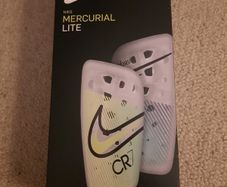 Nike, Mercurial Lite Size Medium shin guards with sleeve.