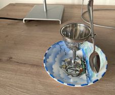 Silver plate egg cup on saucer with ship