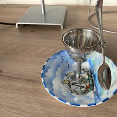 Silver plate egg cup on saucer with ship