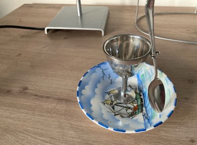 Silver plate egg cup on saucer with ship